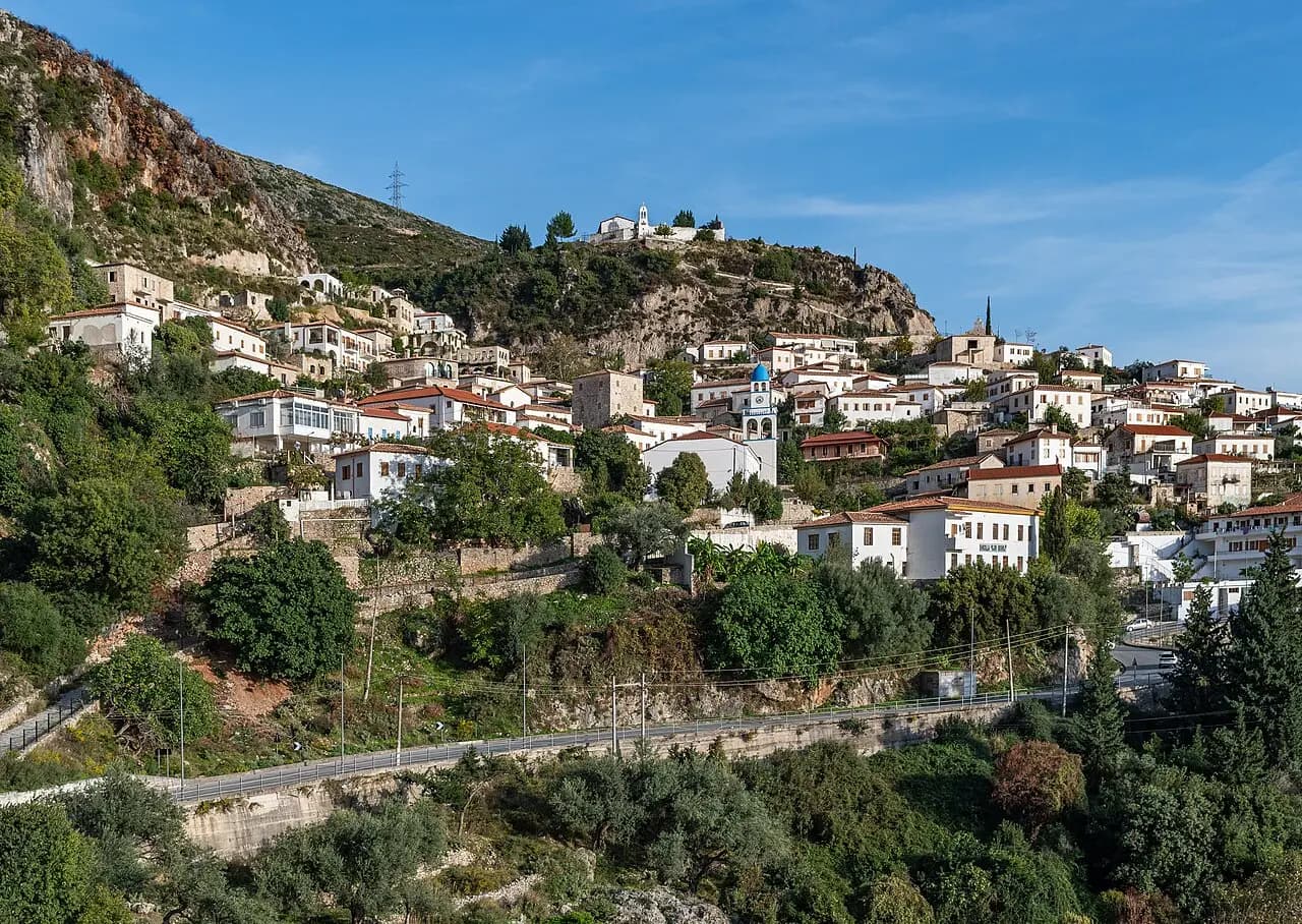 Old town of Dhërmi, Himarë, Albania, with the historic St. Mary's Monastery Church above, surrounded by the Ceraunian Mountains