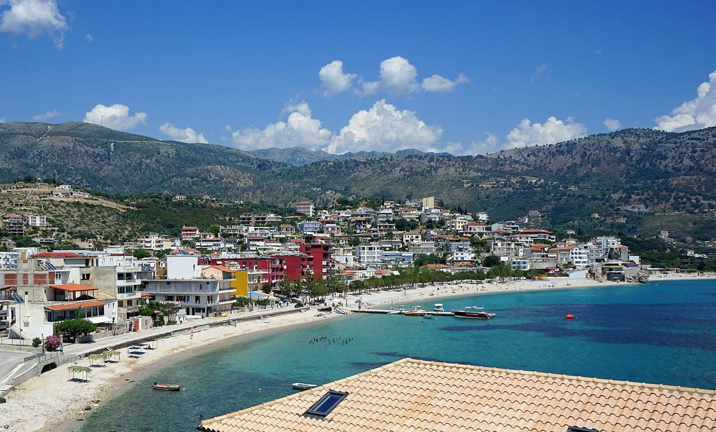 The Town of Himarë on the Ionian Coast in Albania with its beach, the seaside promenade, restaurants and shops in the ce