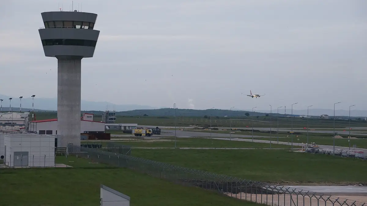 A plane on approach to Prishtina International Airport, beside the control tower