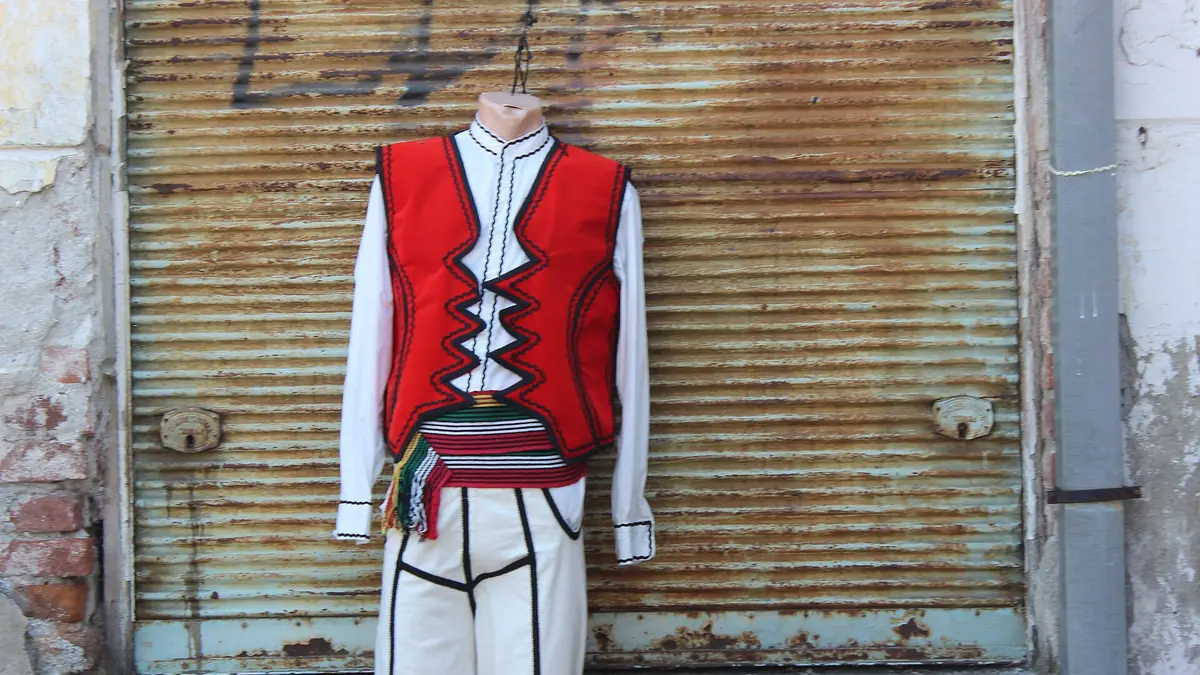 A traditional men's costume outside a shop in Gjakova's Old Bazaar